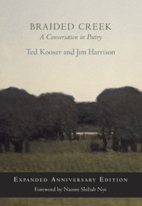 Cover of Braided Creek: A Conversation in Poetry: Expanded Anniversary Edition by Ted Kooser and Jim Harrison, featuring a hazy landscape image below dark blue and green text.