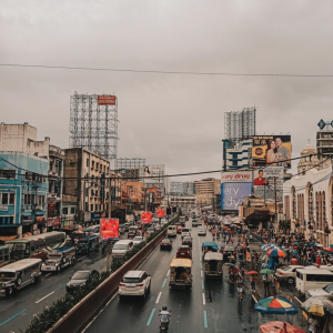 A Reading List for Filipino American History Month featuring a photograph of city streets against a gray sky.