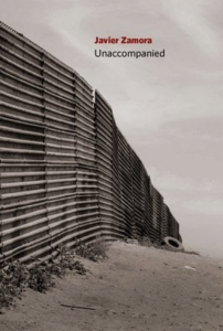 Unaccompanied by Javier Zamora featuring a black and white photograph of a border wall extending into the distance.