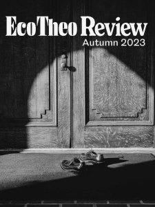 The EcoTheo Review, Autumn 2023: The Understory featuring a black and white photograph of light shining upon a pair of shoes in front of closed doors.