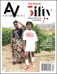 African Voices Magazine Issue 43: Hip Hop at 50 featuring a photograph of a two Black women, one in a patterned skirt and one in an oversized white t-shirt, in front of green bushes.