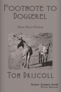 Footnote to Doggerel by Tom Driscoll featuring a black-and-white photograph of two donkeys against a gray background. 