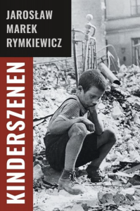 Kinderszenen by Jarosław Marek Rymkiewicz featuring a black and white photograph of a young boy sitting in rubble with the title in a red border on the side.