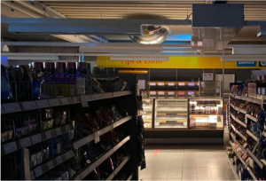 Cover image for "Grocery Store Lockdown" by Russell Reza-Khaliq Gonzaga, featuring a photo of a darkened grocery store aisle.