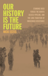 Cover of Our History Is the Future: Standing Rock Versus the Dakota Access Pipeline, and the Long Tradition of Indigenous Resistance by Nick Estes, featuring lime green and orange text over a brown-tinted photograph of a large group of people in winter clothing standing in a snowy landscape. 