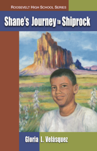 Cover of Shane's Journey to Shiprock by Gloria L. Velásquez featuring an illustration of a young man smiling and standing in front of a grassy green and purple landscape with a tall brown rock in the center.